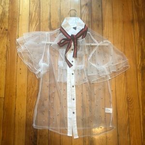 See through, white button down blouse.